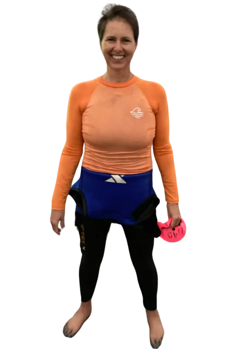 Woman smiling with a pink yoga block, promoting healing and self-care.