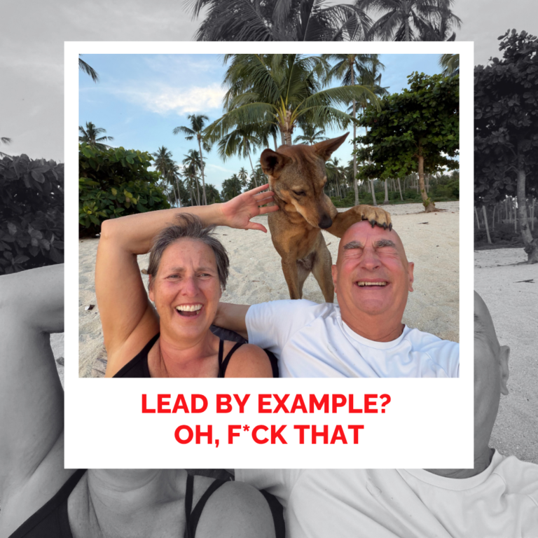 Laura Foster and David smiling with dog on tropical beach with palm trees.